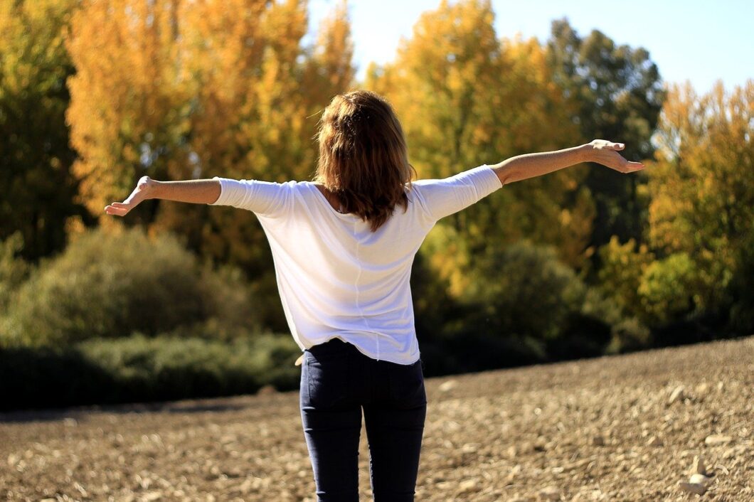 femme sereine qui prend une respiration profonde en pleine nature