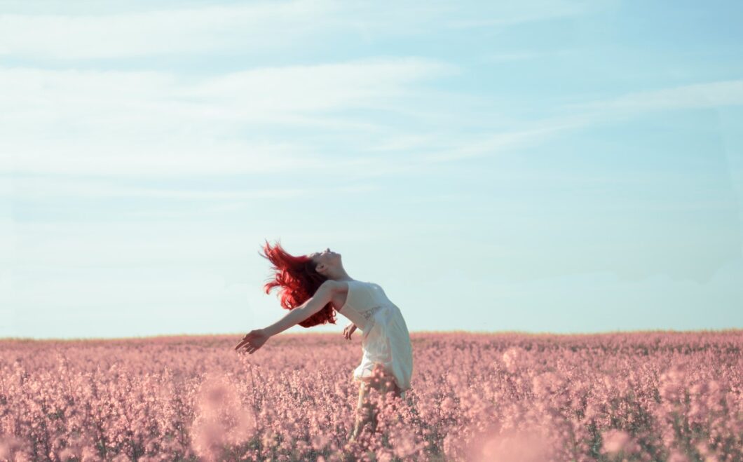 femme libre et sereine dans un champ de fleurs